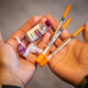 Someone showing off their insulin kit. People with diabetes often need a supply of artificial insulin to regulate their blood sugar.